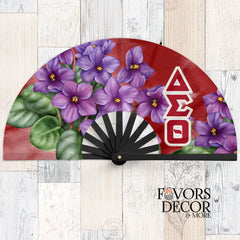 Delta Sigma Theta clack fan with bold red background, large purple African violets, and white Greek letters ΔΣΘ along the side.