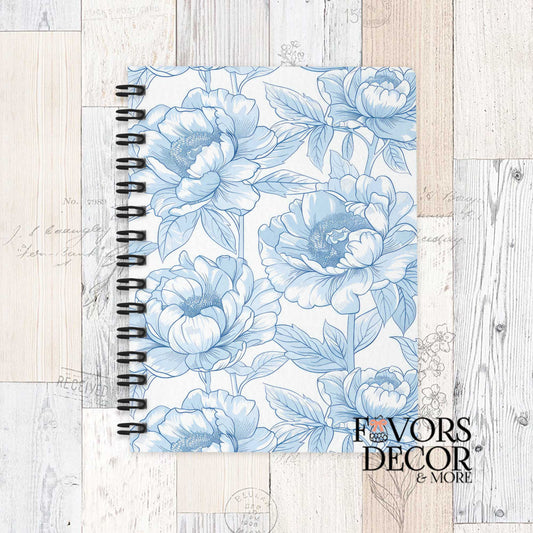Spiral notebook with soft blue peony floral sketch design on a light background, displayed on a rustic wood surface with “Favors Decor &amp; More” logo.