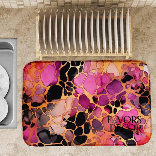 Berry Cheetah Dish Drying Mat placed on a kitchen counter next to a sink and dish rack, displaying its bold abstract cheetah print in full, with vibrant pinks, purples, oranges, and black, ready for use.
