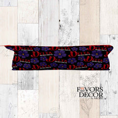 Decorative headband with floral and letter design on a wooden surface, branded 'Favors Decor & More'.