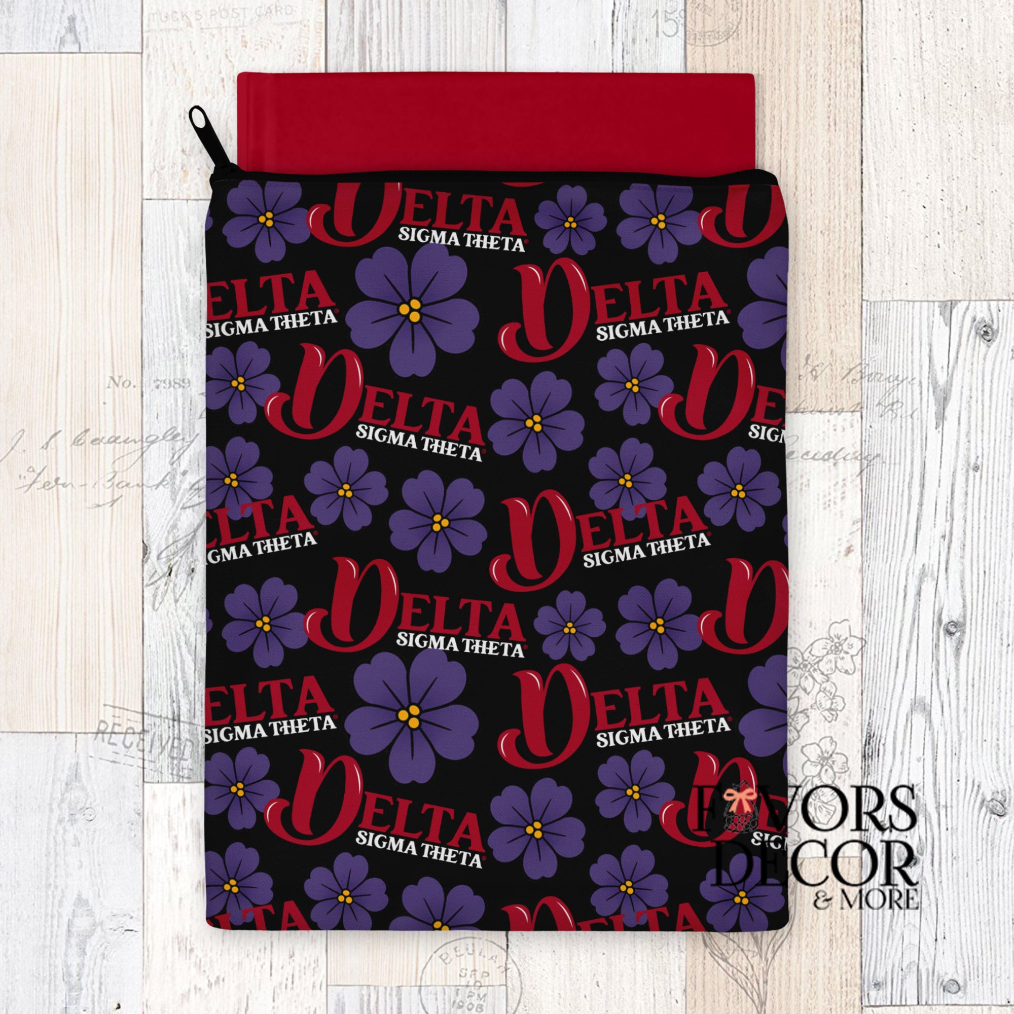 Delta Sigma Theta book sleeve with red DST lettering and purple African violet print on black background, red interior, and zipper closure.