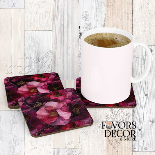 Dusky Blooms Coasters with a white coffee mug sitting on one, showcasing a luxurious abstract floral design in deep magenta and plum tones with shimmering gold outlines, against a light wood background