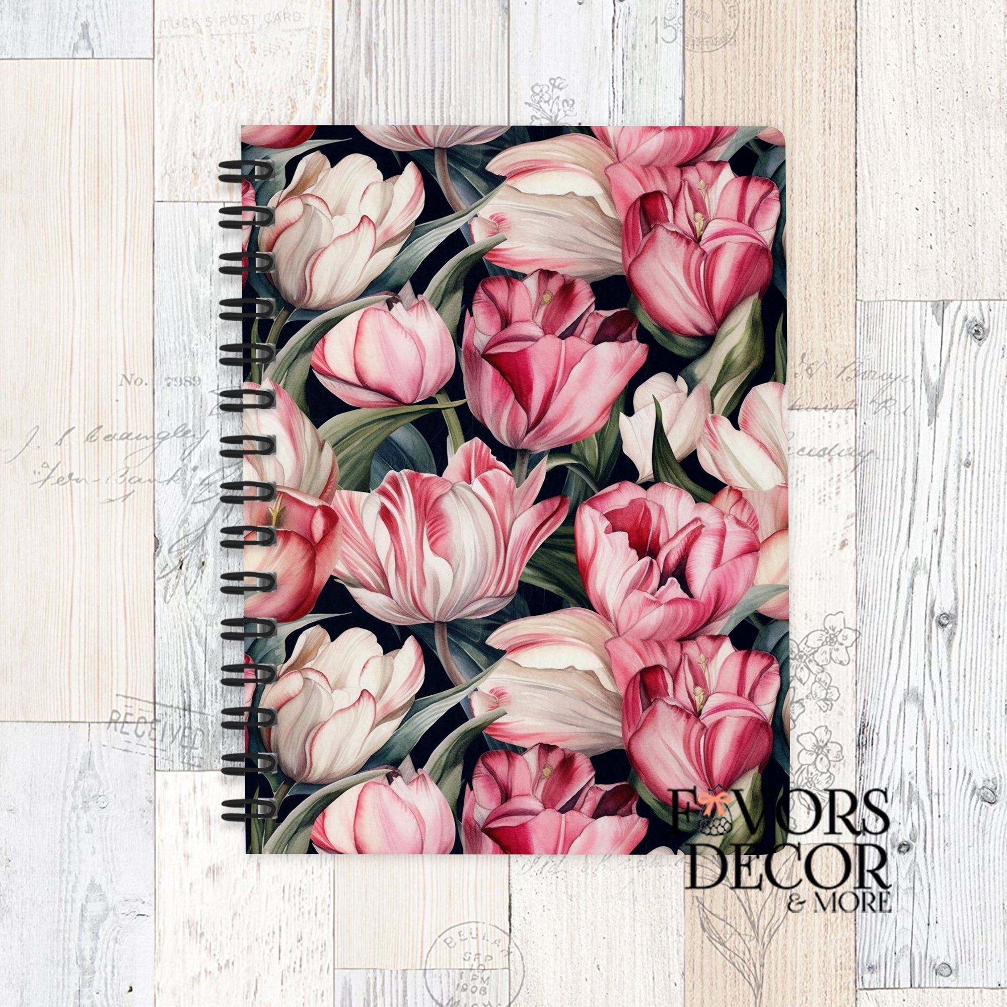 Spiral notebook featuring blush and crimson tulip floral artwork on a dark background, shown on a rustic wood surface with “Favors Decor &amp; More” logo.