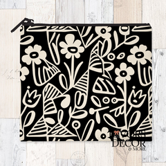 A reusable sandwich pouch featuring a black and white abstract botanical or leaf pattern on the exterior. The pouch has a white zipper closure and is made with a food-safe PUL fabric lining.