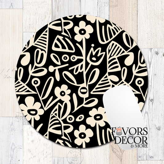 Round mouse pad with bold black botanical line art of flowers and leaves on a cream background, featuring a smooth fabric surface and non-slip rubber backing.