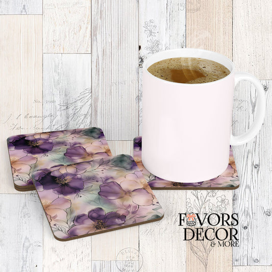Set of square coasters with a lavender and purple watercolor floral design on a light wooden surface, with a white mug resting on one.