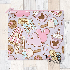 A reusable pouch with a pastel-colored pattern of Disney-inspired treats, including Mickey Mouse shaped ice cream bars, whipped drinks, cookies, popcorn, and balloons. The pouch has a pink zipper closure.