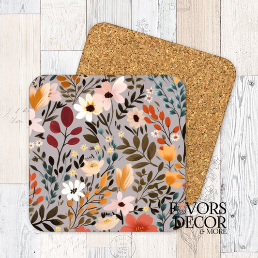 Square cork-backed coaster with warm fall florals in orange, mustard, red, and taupe tones on a soft gray background.