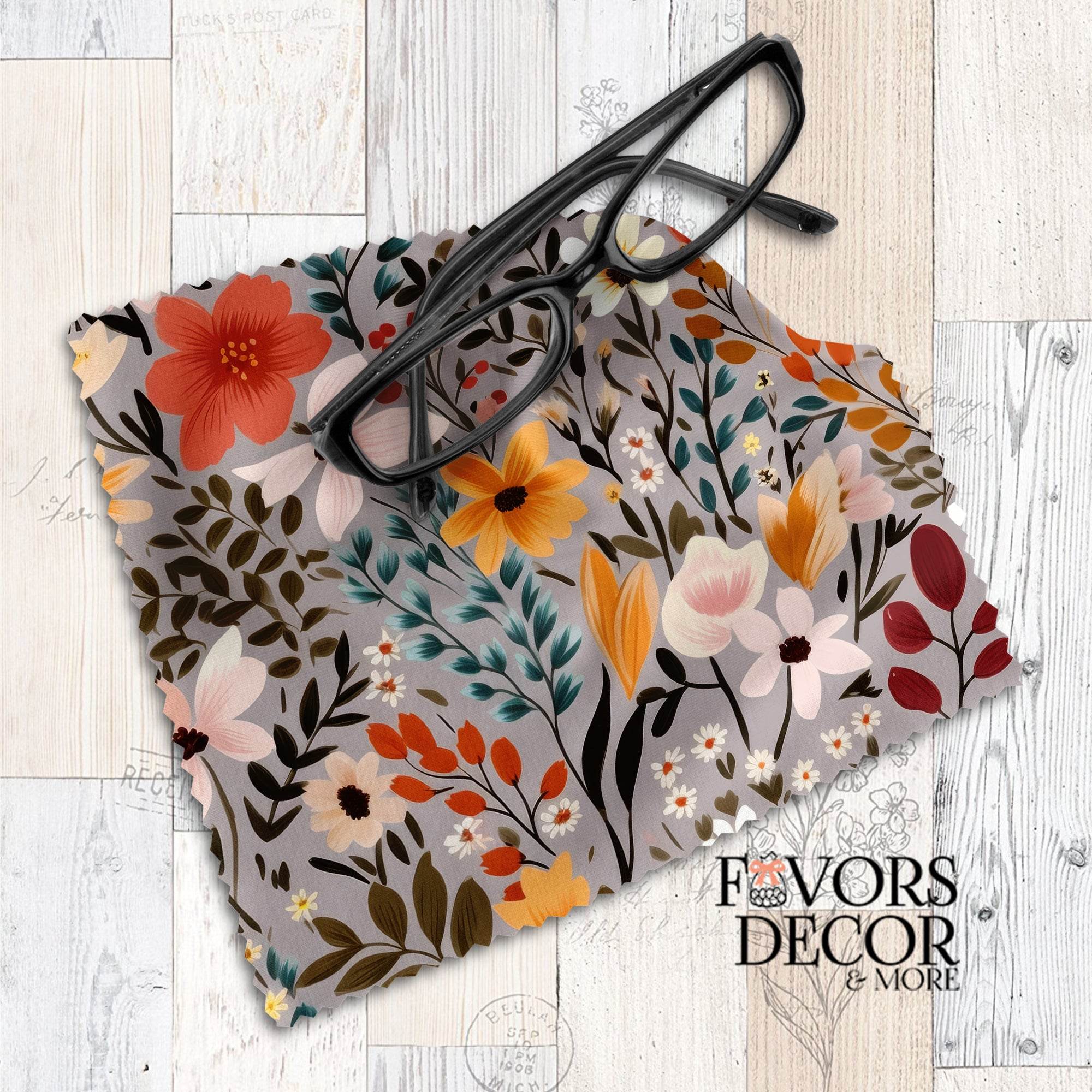 Autumn-inspired lens cloth featuring orange, yellow, teal, and ivory florals on a taupe background, styled with black eyeglasses.