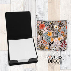 Floral-patterned pouch with a black rectangular item on a wooden surface, branded 'Favors & Decor'.