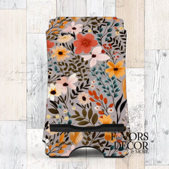 Phone stand featuring the Maple Harvest design with orange, yellow, blush, and ivory florals on a soft gray background.