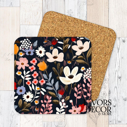 Square floral coaster with dark navy background and ivory, red, and blush flowers; cork backing shown.