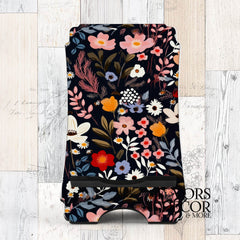 Phone stand with dark floral Midnight Garden design featuring red, blush, ivory, and blue flowers on a navy background.