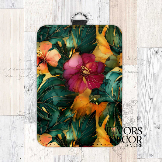 Monstera Drift Card Holder with a lush pattern of green monstera leaves, pink and orange hibiscus flowers, and gold accents, featuring a black keychain ring.