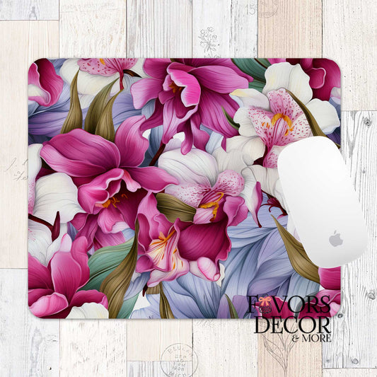 Mouse pad with vibrant magenta, cream, and lavender orchid floral design, shown with a white Apple mouse and “Favors Decor &amp; More” branding on a rustic wood background