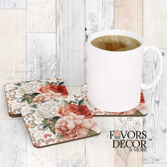Coasters with watercolor florals in peach and white tones over a taupe leopard print background, styled with a coffee mug on wood.