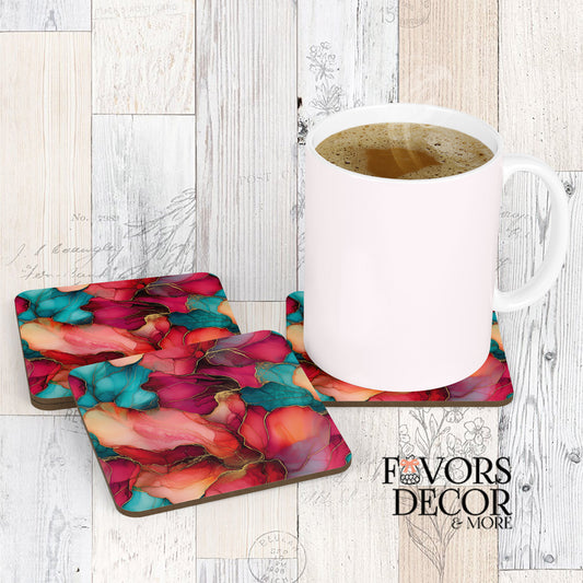 Ruby Dritz Coasters.jpg": alt="Three Ruby Dritz Coasters with a white coffee mug sitting on one, showcasing a vibrant abstract design with flowing shapes in deep ruby red, fuchsia, and teal colors, accented with gold lines.