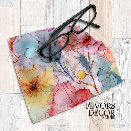 Microfiber lens cleaning cloth with pastel alcohol ink floral design in blush, yellow, and teal, with black eyeglasses placed on top