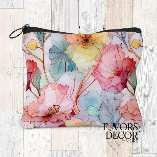 Serene Botanica Pouch with a soft watercolor floral design featuring pink, yellow, blue, and red flowers, set against a light wood background. The pouch has a black zipper.