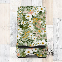 Phone stand with Soft Meadow design featuring white, yellow, and peach flowers on a sage green background.
